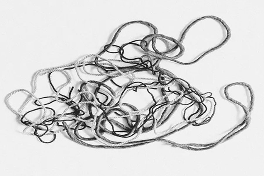 Black and white photo of tangled strings