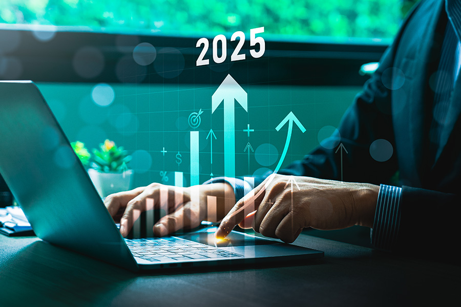 Businessman Analyzing 2025 Financial Growth Projections on Laptop with Digital Bar Graphs and Arrows